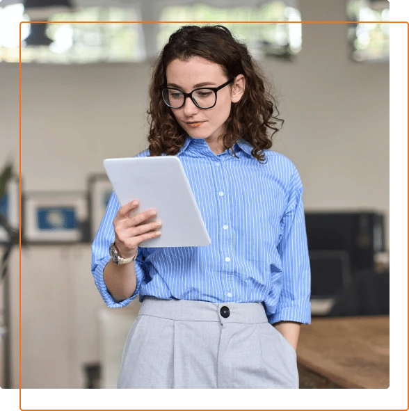Photo of a professional woman with glasses using a tablet device.